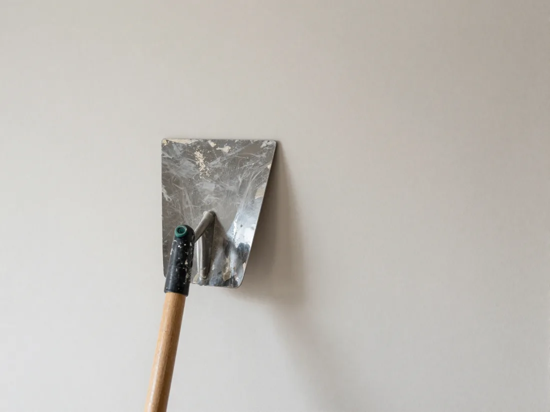 Smooth freshly skimmed interior wall with a plasterer's trowel